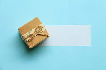 gift box with paper card on blue background.top view.