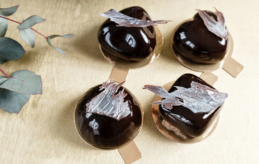 Delicious chocolates cakes. Glossy glaze and chocolate decor. Four different forms. dessert pie for sale at the shop.
