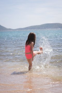 Girl playing in the water at beach