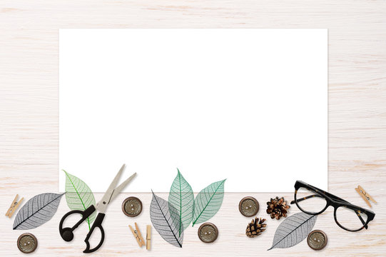 Craft elements and tools with white card on white painted wood