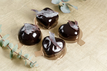 Delicious chocolates cakes. Glossy glaze and chocolate decor. Four different forms. dessert pie for sale at the shop.