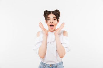 Fototapeta na wymiar Photo closeup of excited teenage woman with double buns hairstyle and dental braces shouting in surprise or delight raising hands at face, isolated over white wall