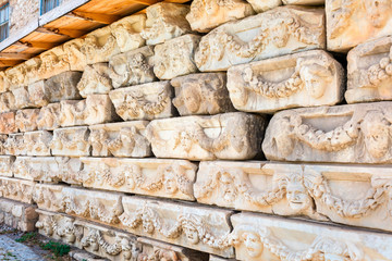 Weathered stone carved panels at the Archaeological site of Helenistic city of Aphrodisias in  western Anatolia, Turkey.