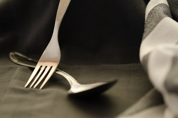 On napkin texture with fork spoon top view,dark style