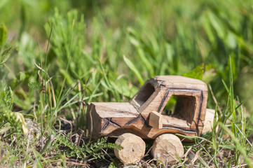 SUV toy car in nature / Wooden SUV, toy car in an extreme landscape.
