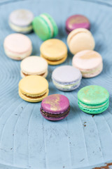 French macaroon dessert and flowers eucalyptus on a turquoise background. pastel colors