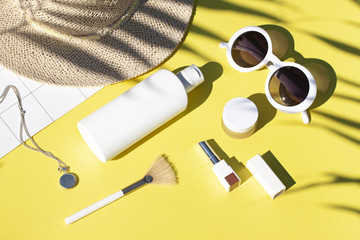 Summer yellow cosmetics flat lay with sunglasses . Top view beauty composition  