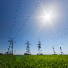 powerline in direct sunlight / bright day the landscape in backlighting