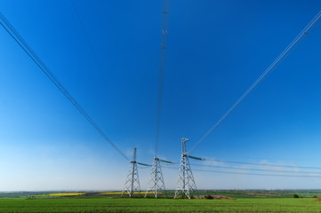 power line summer landscape / passing overhead electricity wire of the support carrying the light and the heat in the house