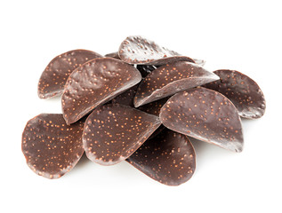 Chocolate chips close-up isolated on white background.