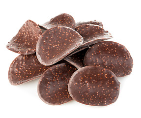 Chocolate chips close-up isolated on white background.
