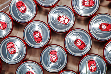 Metal cans with cooling drinks on a white background