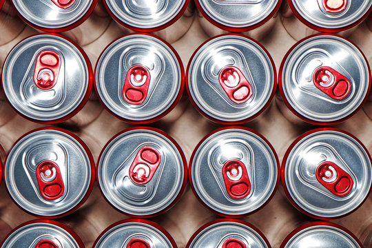 Metal cans with cooling drinks on a white background