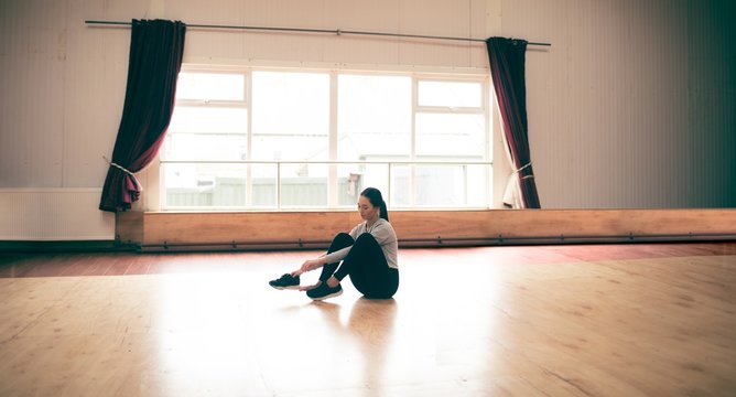Female dancer wearing shoes in dance studio
