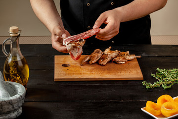 Preparing quail specialty, rolling quail with bacon