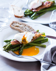 summer lunch aspargus and poached egg on a white table