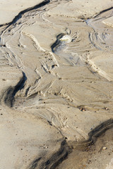 View on beautiful sandy structures and lines caused by waves on the beach