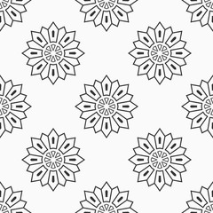 Abstract seamless monochrome floral mandala pattern.
