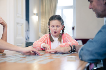 Family playing memory on table at home