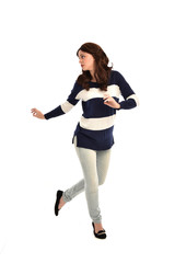 full length portrait of girl wearing striped blue and white jumper and jeans. standing pose on white studio background