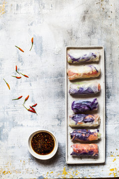 Vegan rice paper wraps Vietnamese summer rolls, filled with cabbage, carrots, bell pepper, rice noodles, and dipping sauce