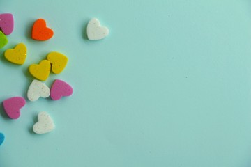 Obraz premium Mini colorful heart on blue background.
