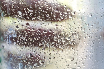 water vessel water drops on glass texture background. hand behind glass