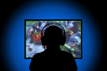 Silhouette,Young man playing video games on pc at home