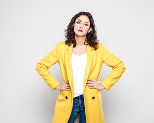 Portrait of displeased young woman in yellow jacket