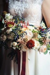 Stunning bridal bouquet. Wedding ceremony. Mix of peony, succulents, orchids and roses. Modern bridal accessories. Wedding flowers