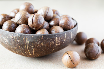 Whole Macadamia nuts in coconut bowl
