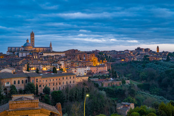 Fototapeta premium Scenery of Siena, a beautiful medieval town in Tuscany, with view of the Dome & Bell Tower of Siena Cathedral
