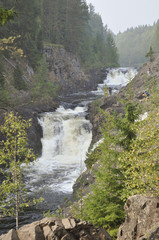 Fototapeta na wymiar mountain low waterfall with a rapid current