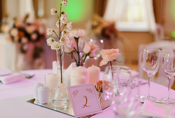 Wedding tables set for banquet or wedding event catering. Party celebration wedding concept. Flowers wedding decoration of tables for guests of bride and groom. Table appointment event