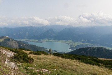 Fototapeta premium Panoramic view of mountains from Schafberg peak in Salzkammergut, Austria in a beautiful summer day