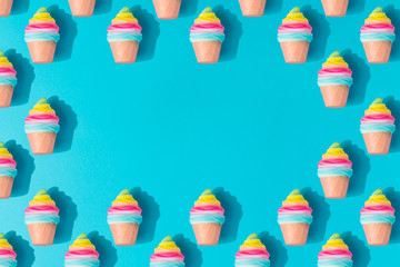 Colorful ice cream pattern on pastel blue background. Creative minimal summer flat lay.