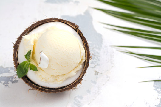 Coconut ice cream scoops in halves of coconut shell