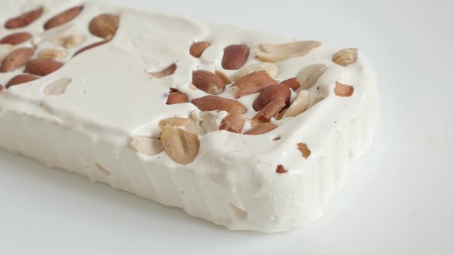 Sweet honey nougat halva with almonds 4K pan footage