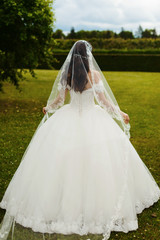 Silhouette of beautiful bride weared in dress and veil. Wedding dress and happiness. Love and new family concept. Honeymoon. Park or interior. Saint-Petersburg wedding tourism. Russian bride