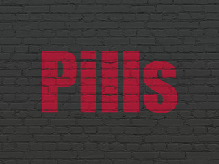 Health concept: Painted red text Pills on Black Brick wall background