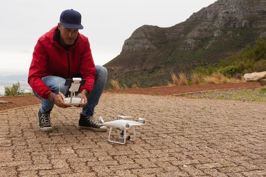 Man operating a flying drone