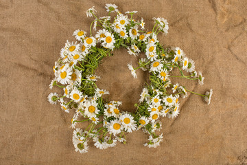 wreath of daisies field flowers on burlap