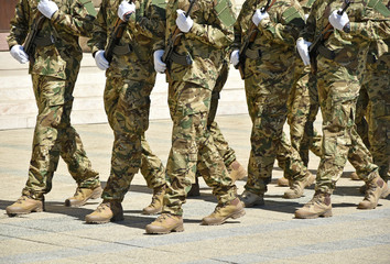 Soldiers are marching at the military parade.