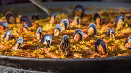 Typical spanish seafood paella in traditional pan close view. Selective focus3