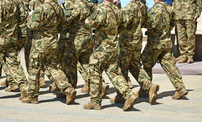 Soldiers are marching at the military parade.