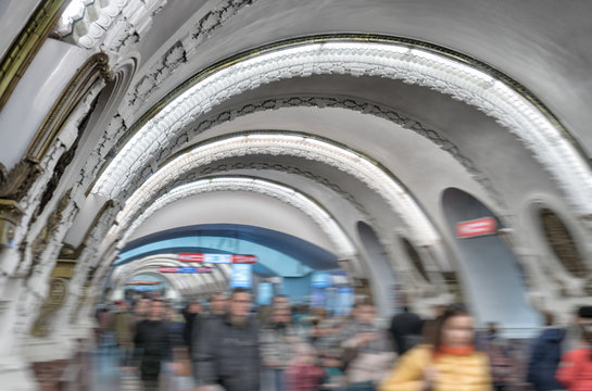 People walking inside metro station in Saint-Petersburg.