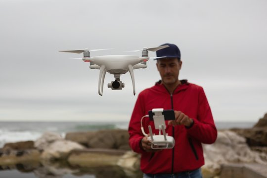 Man operating a flying drone