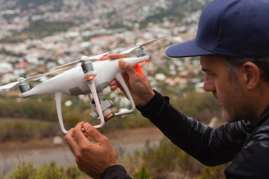 Man holding a flying drone