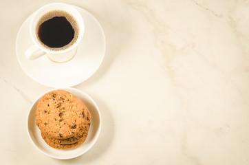 coffee cup and cookies/coffee cup and cookies on a marble background, top view and copy space