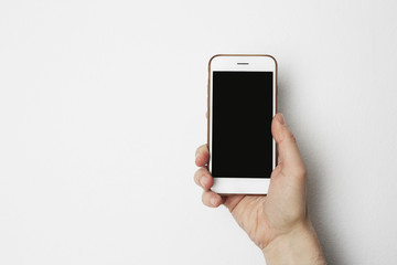 Business objects empty mock-up background for message writing.Mockup of smartphone with empty black screen holding male hand